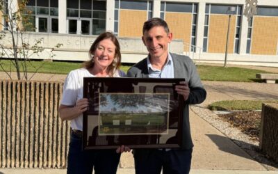 barb earnest with alex keene holding plaque