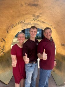 stacy with son and husband in aggie ring